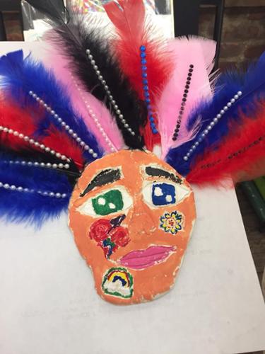 Young Masters Art Class:  Artist of Inspiration Gil Grimmett.  Mask created with air dry class, feathers and other collage materials.